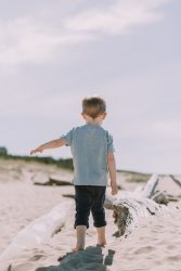 little boy walking on the beach